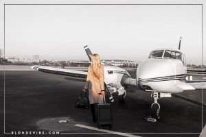 girl walking with suitcase boarding private jet